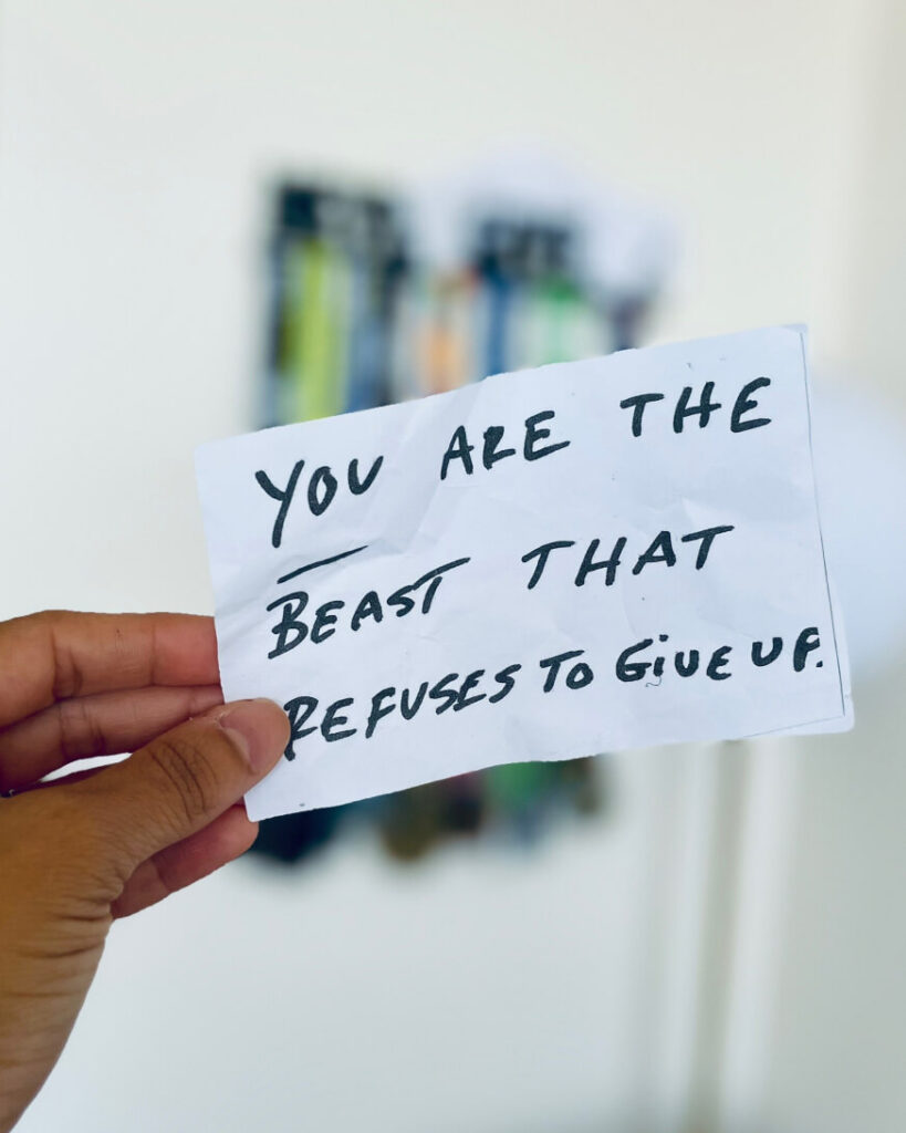 hand showing a motivational note on a paper