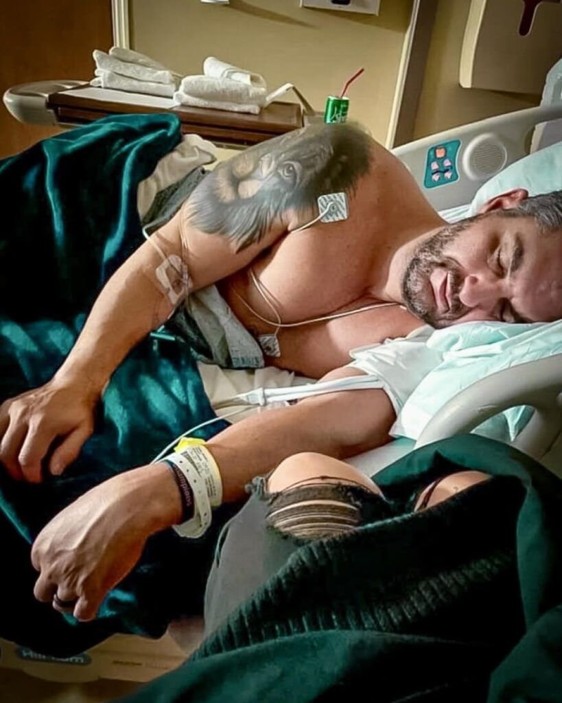 Image of a man laying down on a hospital bed, recovering