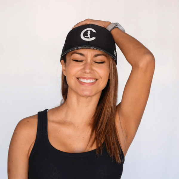 Carleth wearing a CRC performance hat smiling looking at the camera